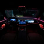 Active ambient lighting displayed across the dashboard and doors of a Mercedes-Benz E-Class W214
