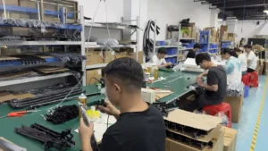 Workers assembling automotive interior upgrade parts in the SJD production workshop
